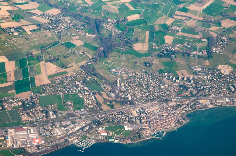 Aerial view of the town of Lausanne, lakefront and the surrounding countryside